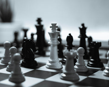 Black and white images of chess pieces in play - Rafael Rex Felisilda-Unsplash
