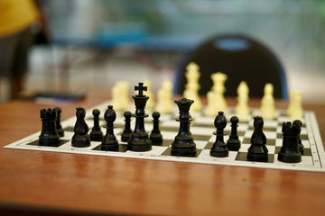 Black chess pieces at the start of a game- Praveen Thirumurugan-Unsplash