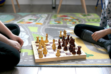 Children-Playing-Chess-on-a-Mat