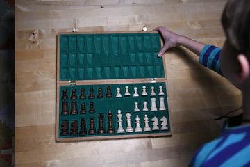 Folding chess set with individual piece storage