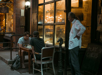 Men Playing Chess Outdoors in the evening