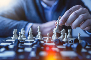 Player holding a white chess king- jeshoots-com-Unsplash