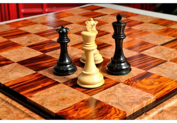 Two chess kings and queens on a luxury chess board