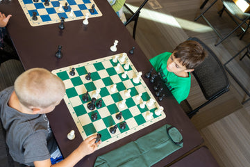 Two children playing chess overhead view