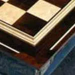 corner of a black and white wooden chess board